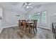 Bright dining room features a wood dining table, chairs, and natural light from large windows at 215 Little Brook Ln, Woodstock, GA 30188