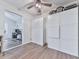 Hallway with wood flooring, ceiling fan, and storage cabinets adjacent to the study area at 215 Little Brook Ln, Woodstock, GA 30188