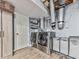 Well-equipped laundry room featuring a modern washer and dryer, cabinetry, and updated wood flooring at 215 Little Brook Ln, Woodstock, GA 30188