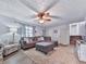 Comfortable living room featuring wood-look floors, ceiling fan, great lighting and cozy seating arrangement at 215 Little Brook Ln, Woodstock, GA 30188