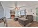 Inviting living room with a stone fireplace, ceiling fan, lots of light and comfortable seating for relaxing at 215 Little Brook Ln, Woodstock, GA 30188