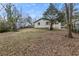 A view of the backyard showing the back of the house and treed perimeter at 2309 Carver Nw Dr, Atlanta, GA 30314