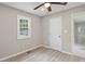 A cozy bedroom features a ceiling fan, new floors, a window, and neutral walls at 2309 Carver Nw Dr, Atlanta, GA 30314