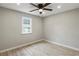 A serene bedroom showcases a window, fan, wood-look flooring, and light gray walls at 2309 Carver Nw Dr, Atlanta, GA 30314