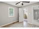 A bedroom features a neutral color palette, wood-look floors, a ceiling fan, and a window at 2309 Carver Nw Dr, Atlanta, GA 30314