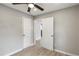 An open bedroom view featuring a neutral color palette, wood-look floors, and a ceiling fan at 2309 Carver Nw Dr, Atlanta, GA 30314