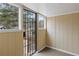 An enclosed porch features wood paneling and windows for natural light at 2309 Carver Nw Dr, Atlanta, GA 30314