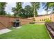 Well-maintained backyard boasts lush synthetic grass, a modern grill, and a privacy fence at 2792 Mathews Se St, Smyrna, GA 30080