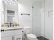 Modern bathroom with updated vanity, granite countertop, toilet and herringbone tiled shower at 2792 Mathews Se St, Smyrna, GA 30080