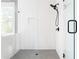 Modern bathroom shower boasts white herringbone tile and matte black hardware at 2792 Mathews Se St, Smyrna, GA 30080
