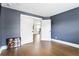 Modern bedroom featuring dark blue walls and hardwood floors, offering a cozy and stylish retreat at 2792 Mathews Se St, Smyrna, GA 30080