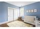 Charming blue bedroom with space themed decor, a cozy crib, and natural light from the window at 2792 Mathews Se St, Smyrna, GA 30080