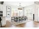 Bright dining room featuring a modern chandelier, dining table, seating, luxury vinyl plank flooring, and white walls at 2792 Mathews Se St, Smyrna, GA 30080