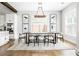 Bright dining room with modern chandelier, seating for six, neutral tones, and luxury vinyl plank flooring at 2792 Mathews Se St, Smyrna, GA 30080