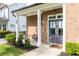 Inviting front porch features a brick facade, stylish double doors, and comfortable seating for relaxing outdoors at 2792 Mathews Se St, Smyrna, GA 30080