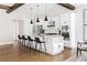 Spacious kitchen features stainless appliances, stone countertops, center island, seating, and wood beams at 2792 Mathews Se St, Smyrna, GA 30080