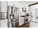 Bright kitchen boasts stainless appliances, gas range, stone counters, subway tile backsplash, and white cabinets at 2792 Mathews Se St, Smyrna, GA 30080