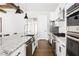 Updated kitchen features stone countertops, stainless steel appliances, gas cooktop, and white cabinets at 2792 Mathews Se St, Smyrna, GA 30080