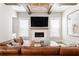 Living room features a TV over fireplace, woven light fixture, comfortable seating, and light walls at 2792 Mathews Se St, Smyrna, GA 30080