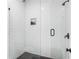 Modern shower featuring white subway tile in a herringbone pattern, glass doors, and sleek hardware at 2792 Mathews Se St, Smyrna, GA 30080