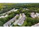 An aerial view of townhome community surrounded by mature trees, near shopping and amenities at 3626 Lantern Crest Cv, Scottdale, GA 30079