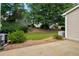 Side view of backyard featuring mature trees, landscaping and partial view of the home's exterior at 3626 Lantern Crest Cv, Scottdale, GA 30079