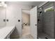 Bright bathroom featuring an updated shower and vanity with a view to the bedroom at 3626 Lantern Crest Cv, Scottdale, GA 30079