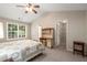 Cozy bedroom with a built-in desk, closet, and a bright window with backyard views at 3626 Lantern Crest Cv, Scottdale, GA 30079