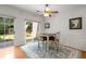 Dining area with wood floors, adjacent to the kitchen, features a sliding glass door to backyard at 3626 Lantern Crest Cv, Scottdale, GA 30079