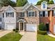 Townhome with brick and siding exterior, well-manicured lawn, and attached garage at 3626 Lantern Crest Cv, Scottdale, GA 30079