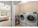 Laundry room featuring a washer, dryer, storage shelves, and access to the bedroom at 3626 Lantern Crest Cv, Scottdale, GA 30079