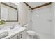 Modern bathroom featuring a tiled shower, vanity with a sink, and updated fixtures at 909 Wentworth Ct, Alpharetta, GA 30022