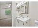Bright bathroom with a vanity sink and view into an adjacent bedroom at 909 Wentworth Ct, Alpharetta, GA 30022