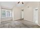 Bright bedroom with large window, neutral carpet, and a ceiling fan at 909 Wentworth Ct, Alpharetta, GA 30022