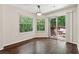 Dining area with hardwood floors, natural light, and sliding glass door to an outdoor balcony at 909 Wentworth Ct, Alpharetta, GA 30022