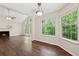 Open dining area with hardwood floors, natural light, and views of backyard trees at 909 Wentworth Ct, Alpharetta, GA 30022