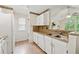 Charming kitchen with white cabinets, modern appliances, and mosaic backsplash at 909 Wentworth Ct, Alpharetta, GA 30022