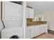 Cozy kitchen with a stackable washer and dryer, plus modern fixtures at 909 Wentworth Ct, Alpharetta, GA 30022