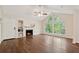 Bright living room boasts a fireplace, built-in shelves, and a large arched window with natural light at 909 Wentworth Ct, Alpharetta, GA 30022