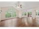 Open living room with hardwood floors, natural light, and sliding door access to a private balcony at 909 Wentworth Ct, Alpharetta, GA 30022