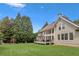Exterior shot showing an expansive, grassy backyard, wooden deck, and lush greenery at 1029 Ector Nw Dr, Kennesaw, GA 30152