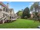 Lush backyard with mature trees, play set and a large grassy area, great for outdoor activities at 1029 Ector Nw Dr, Kennesaw, GA 30152