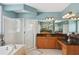 Bathroom featuring a soaking tub, glass-enclosed shower, double vanity, and elegant fixtures at 1029 Ector Nw Dr, Kennesaw, GA 30152
