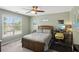 Cozy bedroom features a ceiling fan, neutral carpeting, and a large window offering natural light at 1029 Ector Nw Dr, Kennesaw, GA 30152
