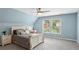 Cozy bedroom with light blue walls, a ceiling fan, and a window providing natural light at 1029 Ector Nw Dr, Kennesaw, GA 30152