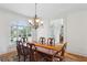 Formal dining room with classic chandelier, and lots of natural light at 1029 Ector Nw Dr, Kennesaw, GA 30152