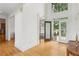 Bright foyer featuring gleaming hardwood floors, soaring ceilings, and decorative glass doors at 1029 Ector Nw Dr, Kennesaw, GA 30152