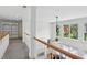 Bright hallway with gray carpet and a white bookshelf and a large window overlooking the backyard at 1029 Ector Nw Dr, Kennesaw, GA 30152
