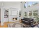 Bright living room with fireplace, built-in shelving, large windows, and comfortable seating at 1029 Ector Nw Dr, Kennesaw, GA 30152