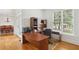 Cozy office space featuring a large desk, natural light, and hardwood flooring at 1029 Ector Nw Dr, Kennesaw, GA 30152
